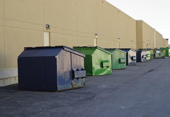 metal waste containers sit at a busy construction site in Calhoun